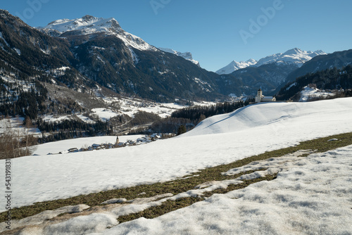 The snow begins to melt on a meadow above the village of Donat in the Valley of Schams in the Grisons, Switzerland