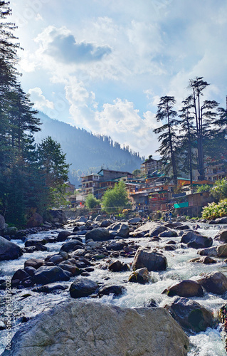 a river flowing in Manali India , a river filled with rock 