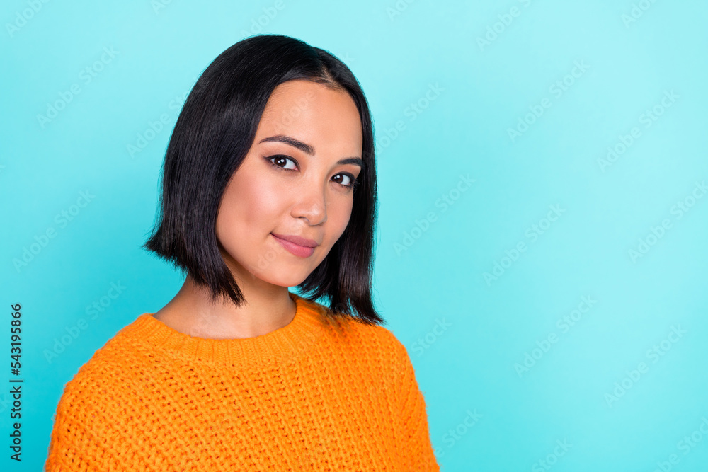 Fototapeta premium Portrait of positive girlish gorgeous woman with bob hairstyle wear orange sweater look at camera isolated on teal color background