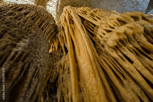 Under the ground. Beautiful view of stalactites and stalagmites in an underground cavern - Postojna cave, Slovenia, Europe photo