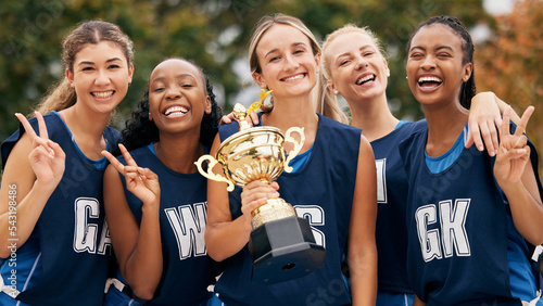 Fototapeta Naklejka Na Ścianę i Meble -  Netball, trophy and winner women with team portrait for success, goal and celebration for competition or game. Happy sports teenager group with motivation, prize and celebrate winning achievement