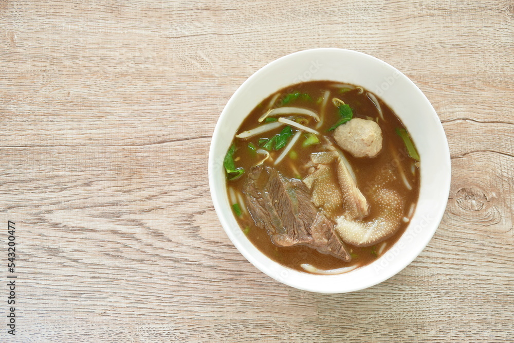 boiled braised beef and meatball in black herb soup on bowl boiled braised beef and meatball in black herb soup on bowl