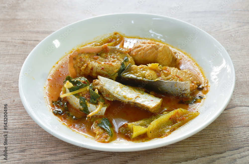 spicy fried Maekong giant catfish with herb and chili on plate