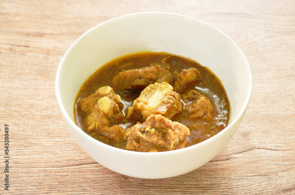 spicy boiled pork bone with curry and basil leaf on bowl spicy boiled pork bone with curry and basil leaf on bowl