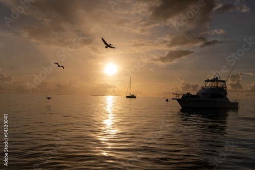 Boats over a background of a golden sunset hour at  Venezuela Los Roques photo