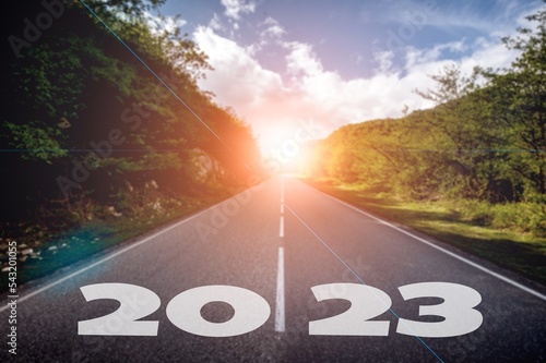 Text 2023 on asphalt road and beautiful nature outdoor.