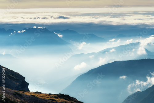 Highland landscape with peaks above the clouds. Beautiful view with big rocks and mountains in thick low clouds. National park Tre Cime di Lavaredo. Dolomiti alps, South Tyrol, Italy, Europe