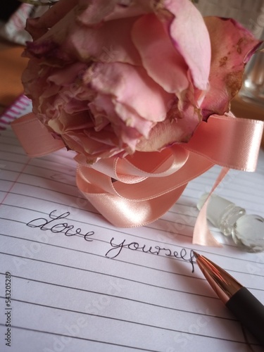 Rose, pen and notebook 