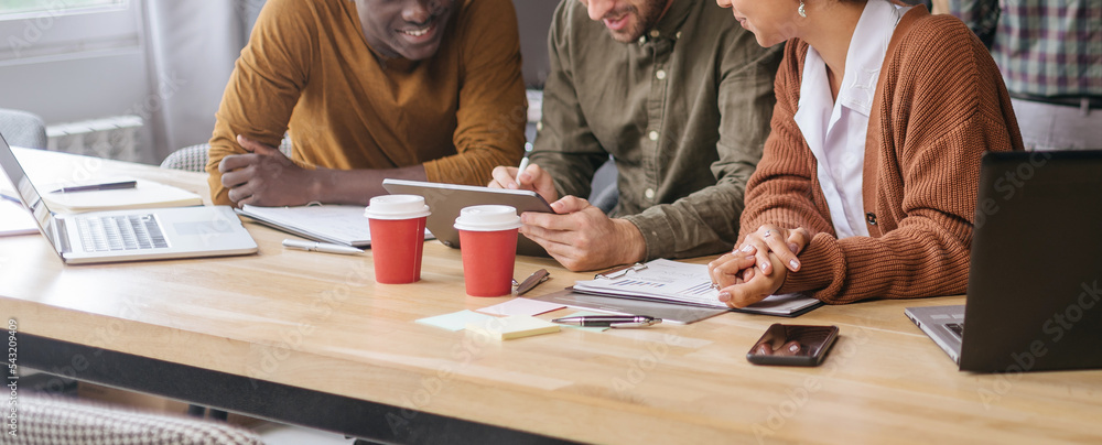 business team using a digital tablet at work in a coworking cent business team using a digital tablet at work in a coworking cent