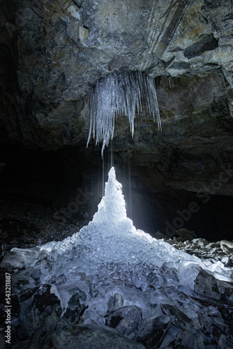 Ice formation and waterfall in an old abandoned mine deep underground.