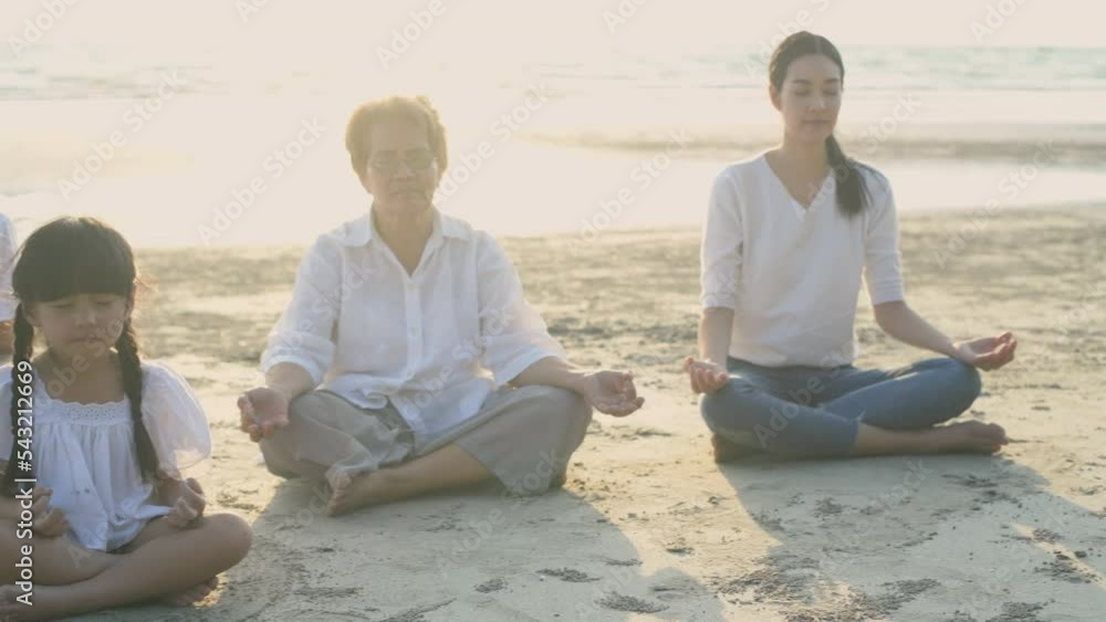 Holiday concept of 4k Resolution. Everyone in the family is doing yoga by the beach. summer vacation travel. Holiday concept of 4k Resolution. Everyone in the family is doing yoga by the beach. summer vacation travel.