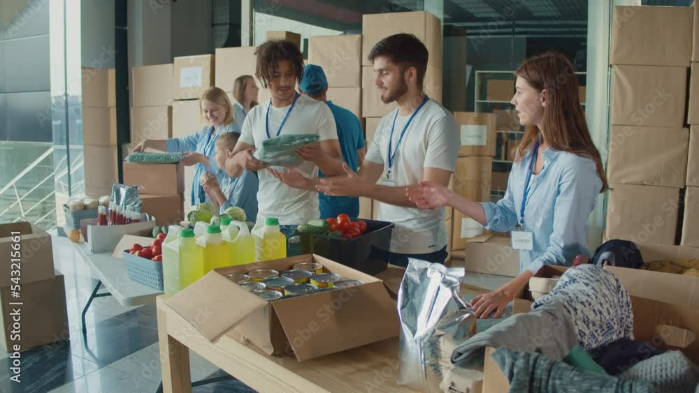 The Concept of Social Aid: A Group of Charity Workers and Community Members of All Ages Sorting Humanitarian Aid at Distribution. Charity, Donation, and Volunteering Concept. The Concept of Social Aid: A Group of Charity Workers and Community Members of All Ages Sorting Humanitarian Aid at Distribution. Charity, Donation, and Volunteering Concept.