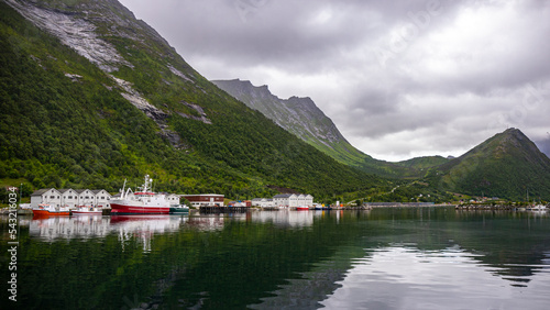 panorama of senja island, norway, overlooking the small island of husoy and its harbour; the famous norwegian fjords