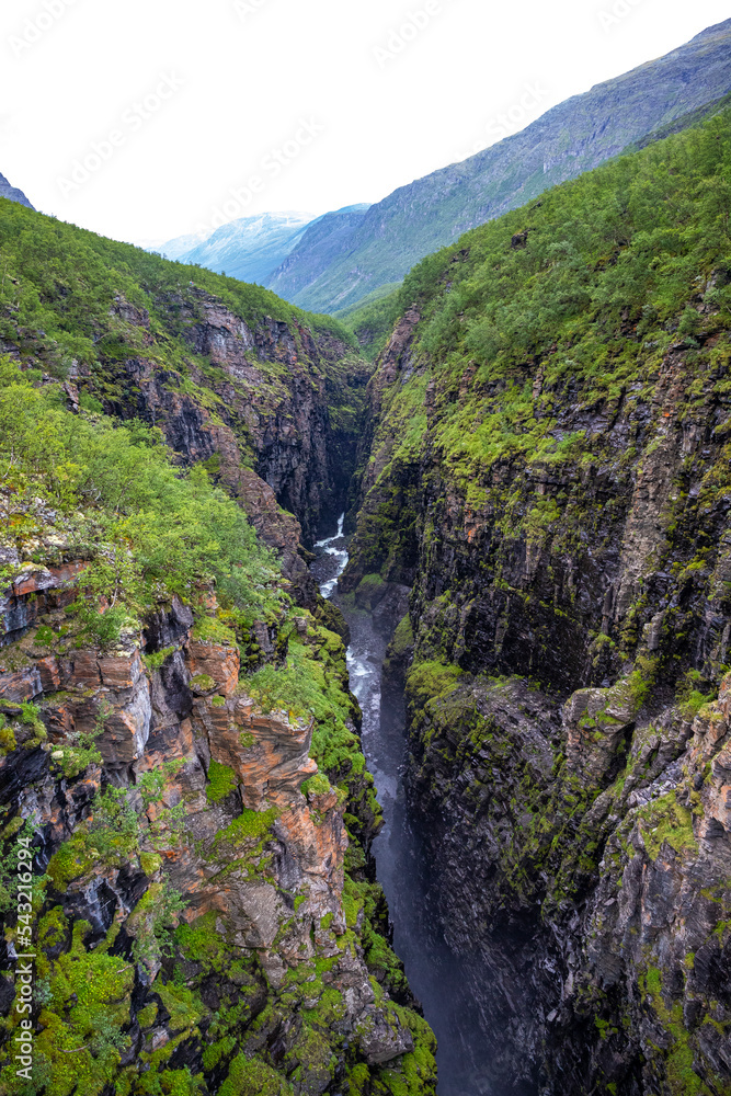 huge canyon with a large waterfall in northern norway, sarafossen in lyngenfjord, northern norway landscape