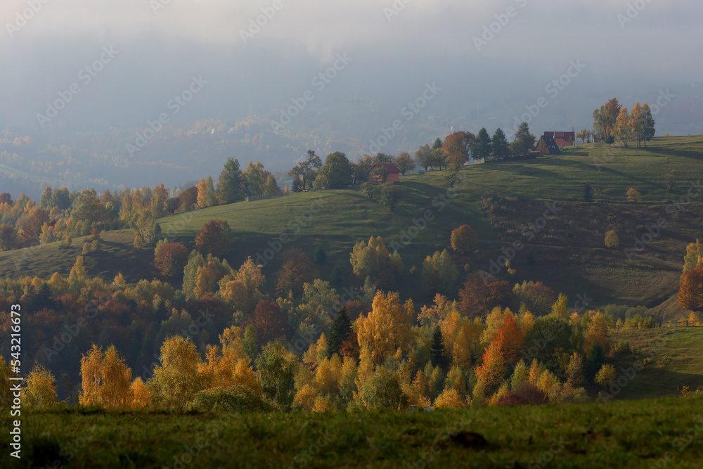 Autumn landscape over Sirnea village from Rucar Bran Pass between Bucegi and Piatra Craiului Mountains with the amazing villages landscapes and old houses.