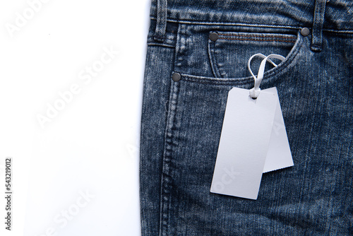 Label price tag mockup on blue jeans on white background