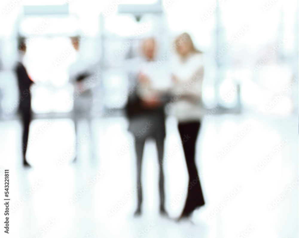 blurry image of a group of business people standing in the office