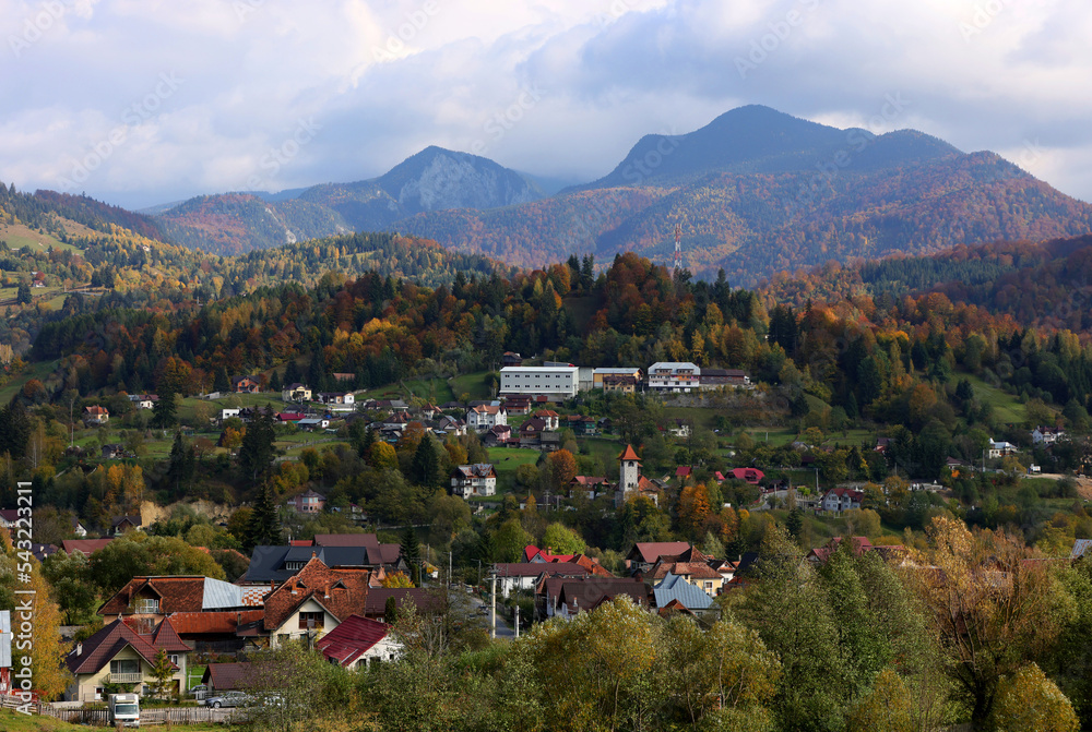 Autumn landscape over Podu Dambovitei village from Rucar Bran Pass between Bucegi and Piatra Craiului.