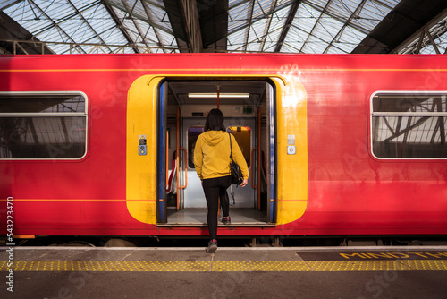 Female passenger entering train photo