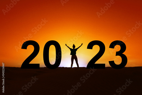 2023, silhouette of a woman standing in the sunrise, women new year greeting card