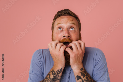 Ginger scared man with beard expressing surprise at camera