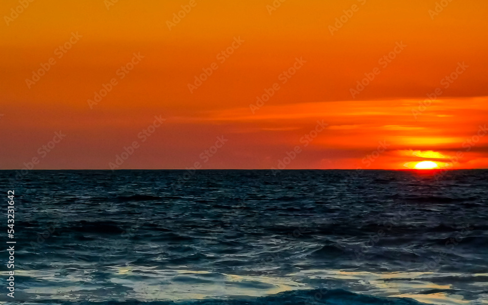 Colorful golden sunset big wave and beach Puerto Escondido Mexico.