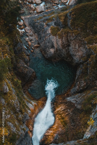 Vertical top view shot of the mesmerizing Poellat Gorge waterfall in Germany, a long exposure photo