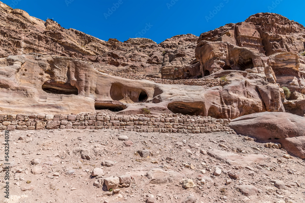 A view of cave dwellings beside the Royal Tombs in the ancient city of Petra, Jordan in summertime