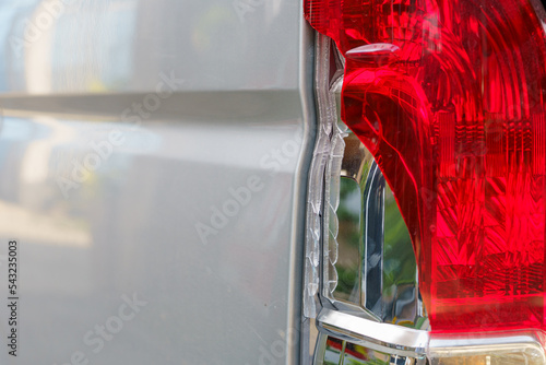The red and white brake lights and reversing lights of the transport van were broken due to a collision.accident and insurance concept