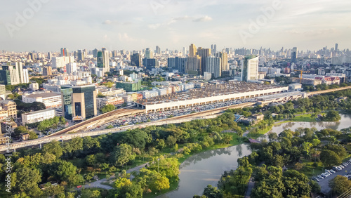 Aerial view of Beautiful cityscape and forest park , City center in sunset.