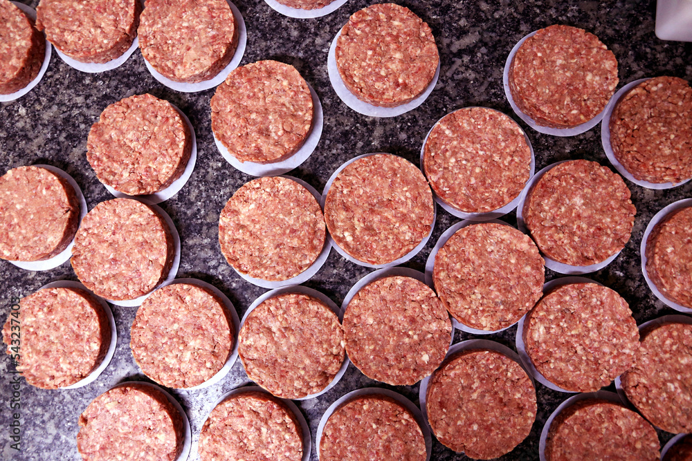 many raw hamburgers outside the restaurant. Starting the preparation of hamburgers. Top view many raw hamburgers outside the restaurant. Starting the preparation of hamburgers. Top view