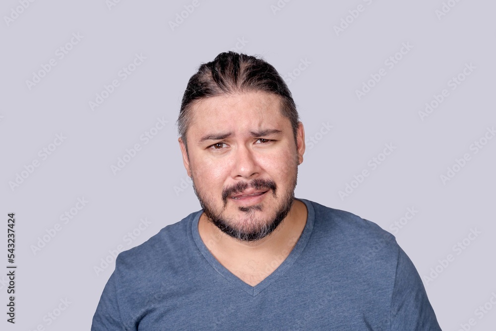 A man in his 30s showing stress and frustration in his facial reactions. Problematic and overwhelmed with mounting troubles. A man in his 30s showing stress and frustration in his facial reactions. Problematic and overwhelmed with mounting troubles.