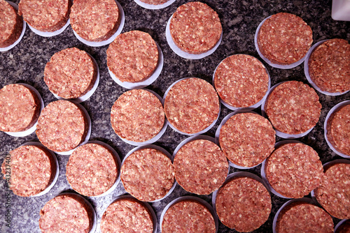 many raw hamburgers outside the restaurant. Starting the preparation of hamburgers. Top view