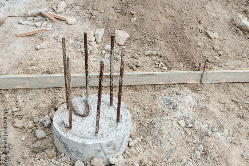 Monolithic foundation with metal reinforcement. Concrete Pile foundation after completed for new construction site. photo