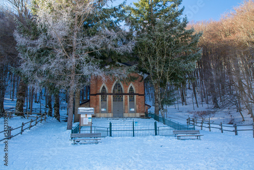 Santissimo Salvatore church on the snow-covered Laceno lake photo