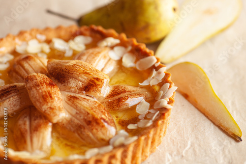 Original pear pie with fruits laying on stone background. Natural daylight. Close up. Indoor shot