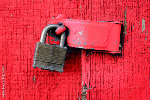 Lock on Hinge on Red Door and Wall