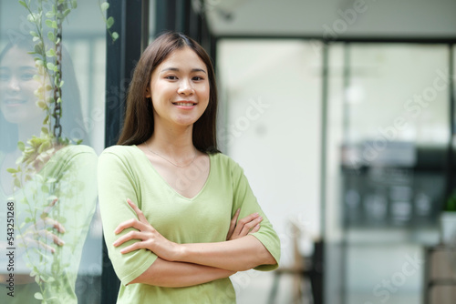 Free Download Portrait of confident woman arms crossed smiling at camera. - GFXLoad