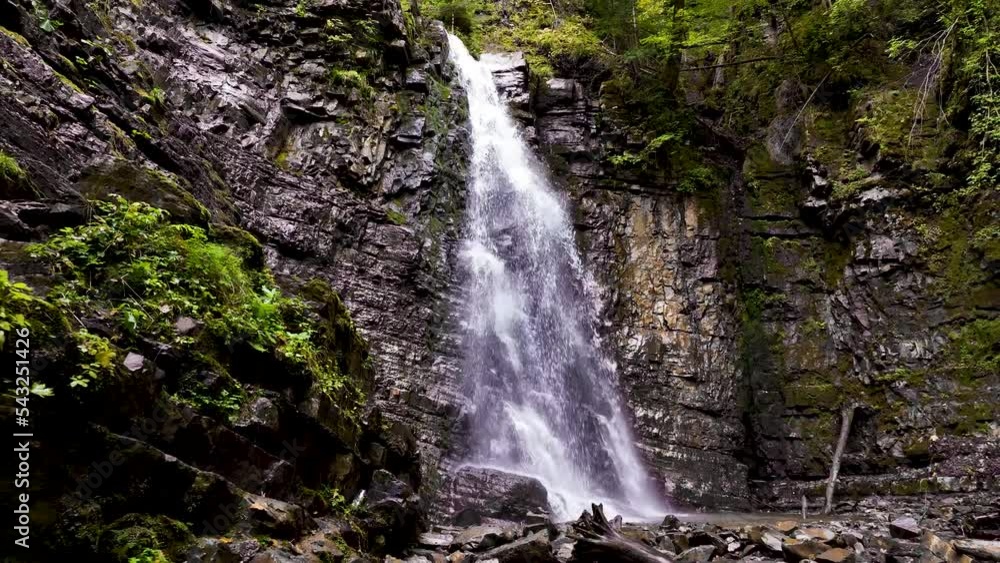 Drone flying over a green forest around a big waterfall in the mountains. Aerial Drone footage 4K. Beautiful nature landscape scene showing the famous waterfall in the Carpathian Mountains, Ukraine Drone flying over a green forest around a big waterfall in the mountains. Aerial Drone footage 4K. Beautiful nature landscape scene showing the famous waterfall in the Carpathian Mountains, Ukraine