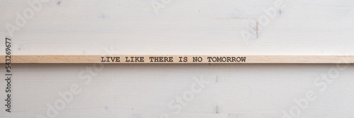 Wooden slat with a Live like there is no tomorrow sign on it