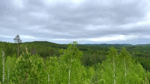 View from Small Devils rock on young firs and birches on sunny day. Iset Park, Iset village, Sverdlovsk region, Russia. Hiking. Damn hillfort.
