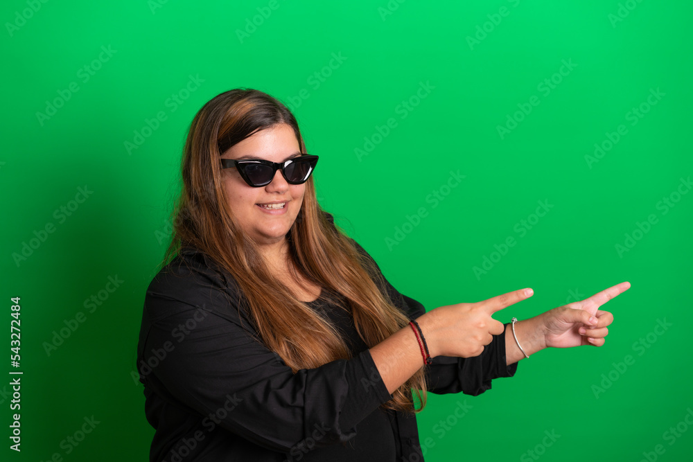 Young woman, wearing black glasses on Green Background Young woman, wearing black glasses on Green Background