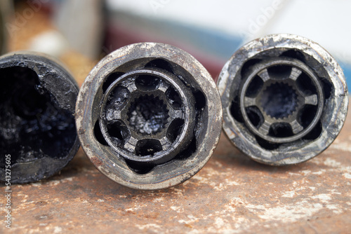 Old used dirty CV joint tripods close-up photo