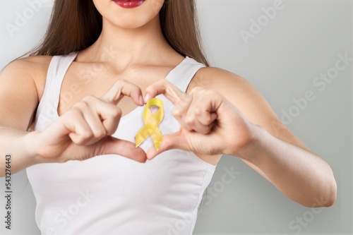 Young woman with yellow ribbon for support people