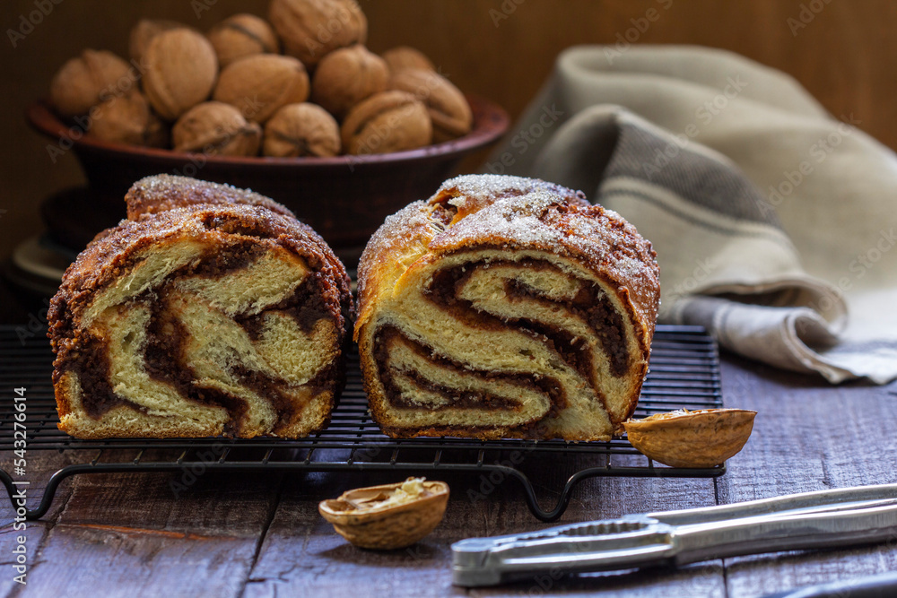 Traditional Easter bread with chocolate and nut filling on a wooden background.