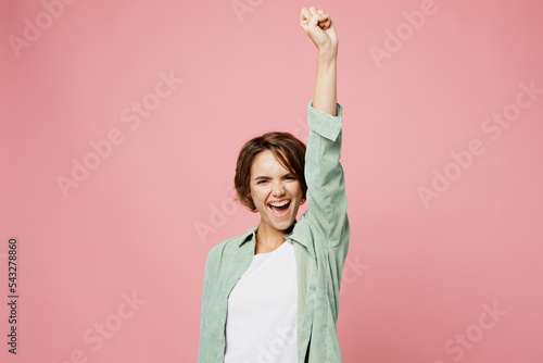 Fotografia Young happy fun cool woman 20s she wear green shirt white t-shirt raise up hand