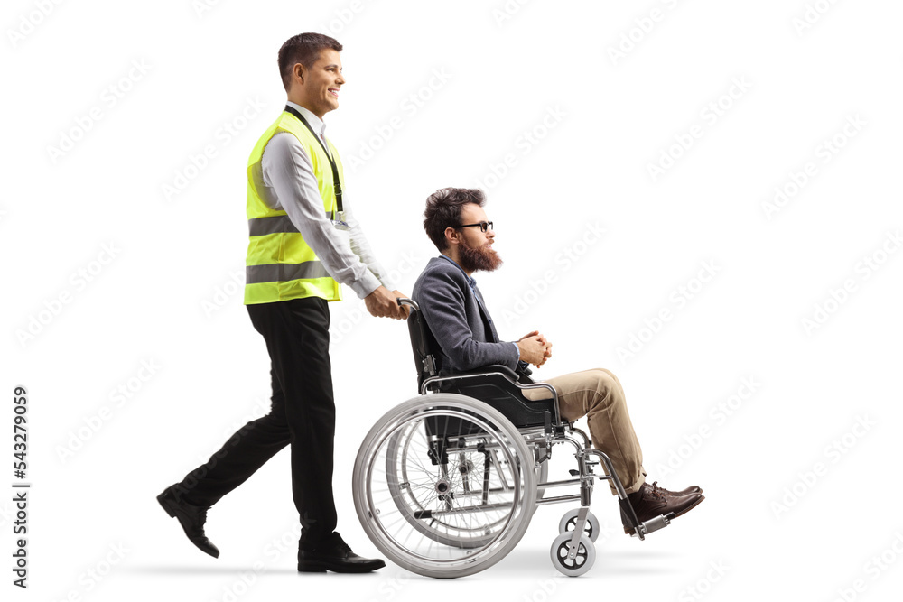 Full length profile shot of an airport worker walking and pushing a man in a wheelchair Full length profile shot of an airport worker walking and pushing a man in a wheelchair
