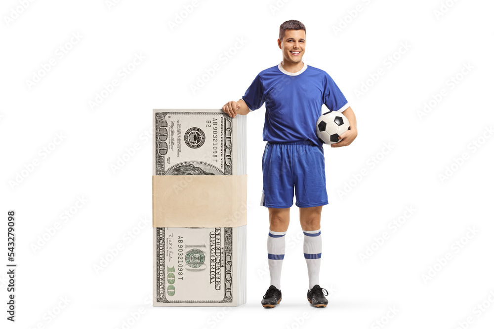 Man in a football jersey standing next to a big stack of money Man in a football jersey standing next to a big stack of money