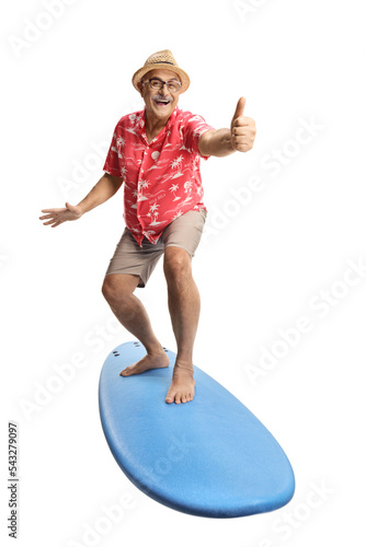 Mature male tourist on top of a surfing board gesturing thumbs up