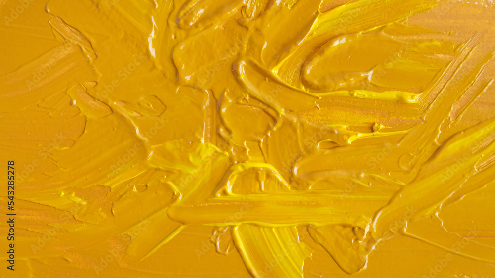 Yellow paint strokes drawn with brush as background, closeup Yellow paint strokes drawn with brush as background, closeup